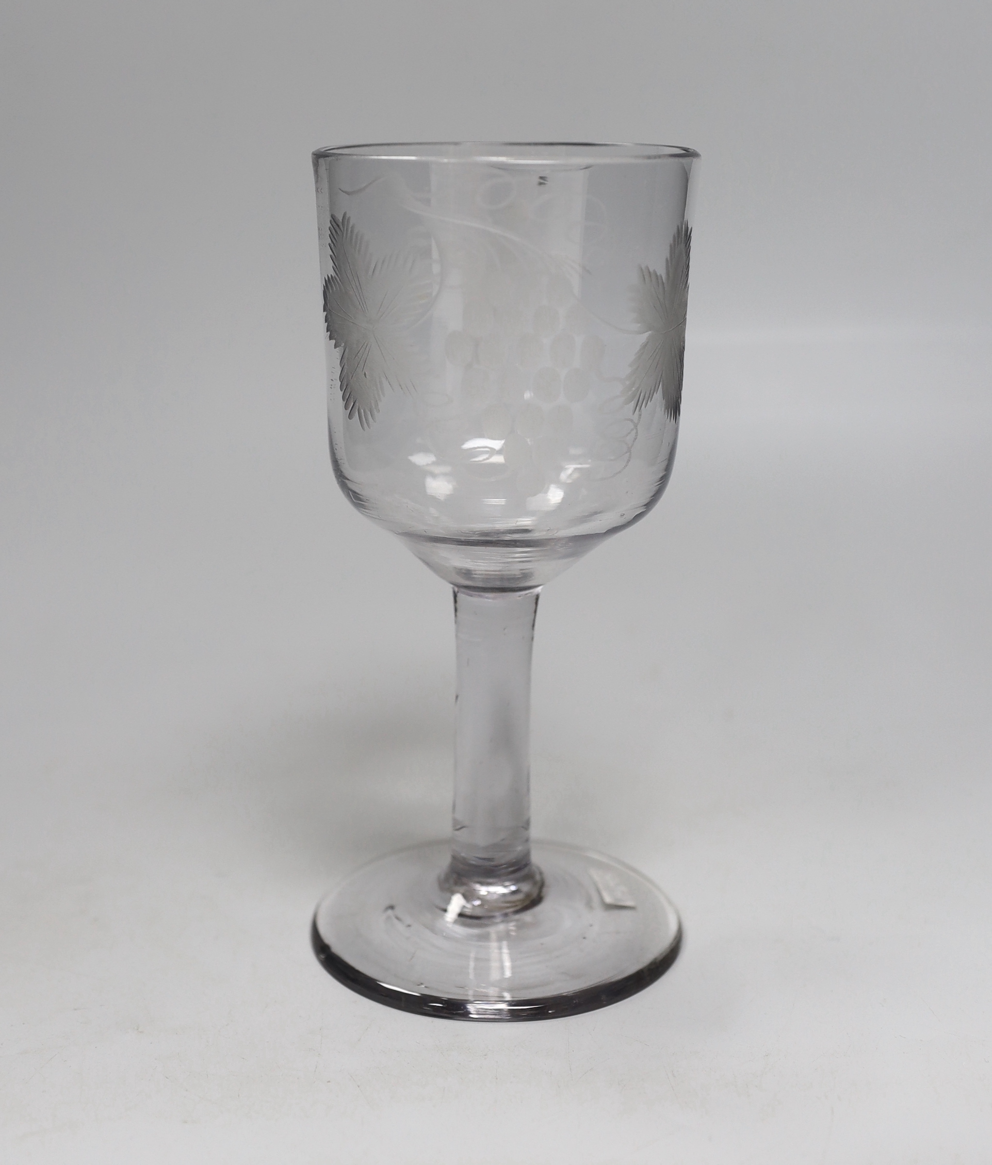 An English lead crystal goblet, c.1740-50, ogee bowl with tool marks, engraved fruiting vines and a bird, with a plain stem, conical foot and rough pontil, 19.4cm